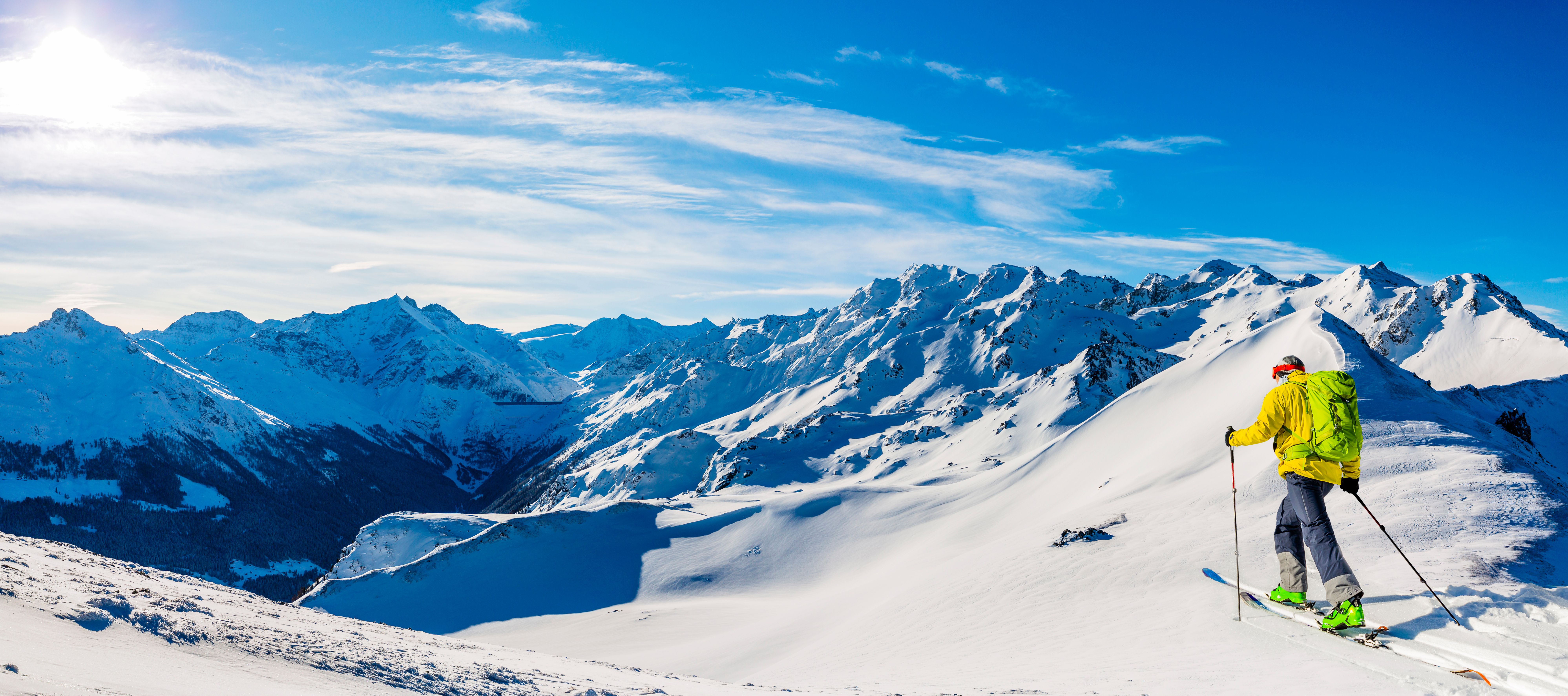 Ski tour in alpine landscape with bright sun
