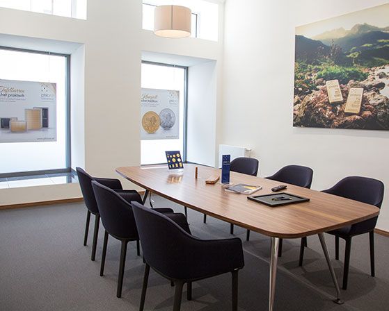 Ein Foto des Beratungsraumes der philoro Filiale in Graz mit einem großen Besprechungstisch und 6 Sesseln.