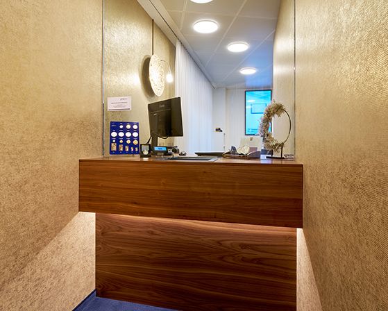 An elegant design room with golden walls and a wooden bar.