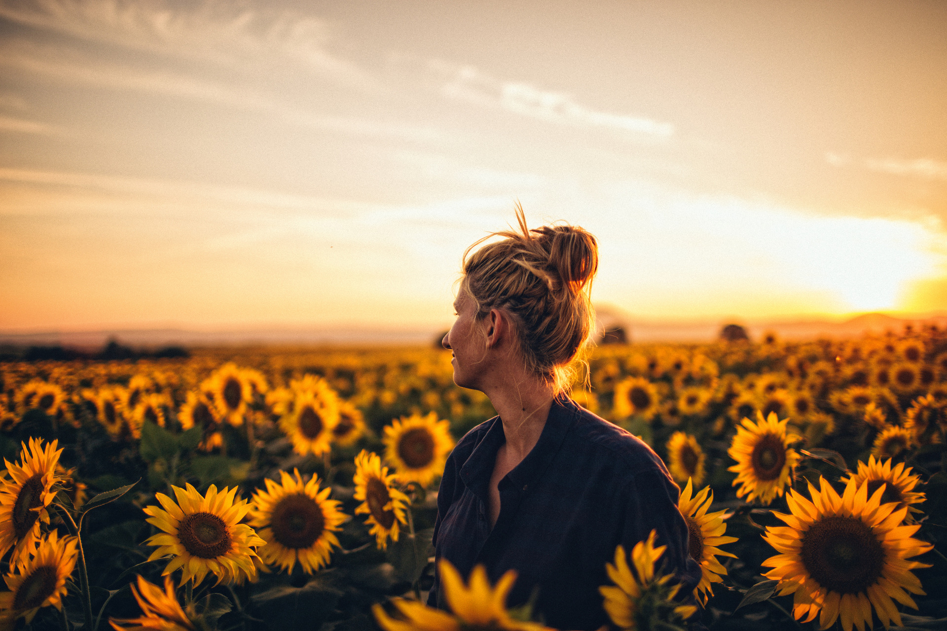 Lady in sunflower field