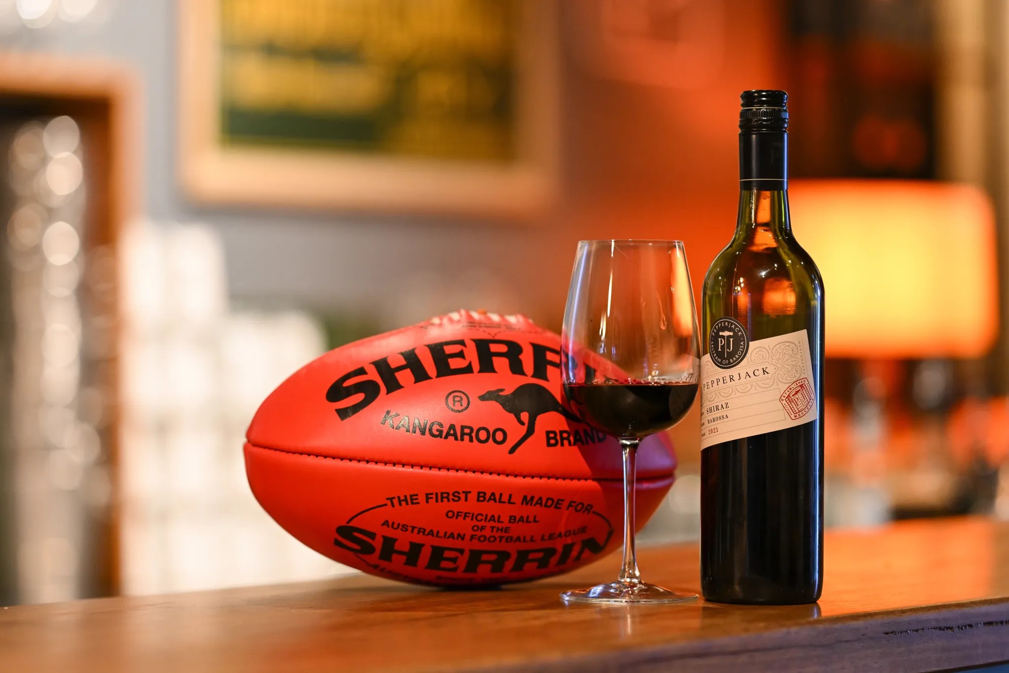 AFL football and bottle of Pepperjack Shiraz