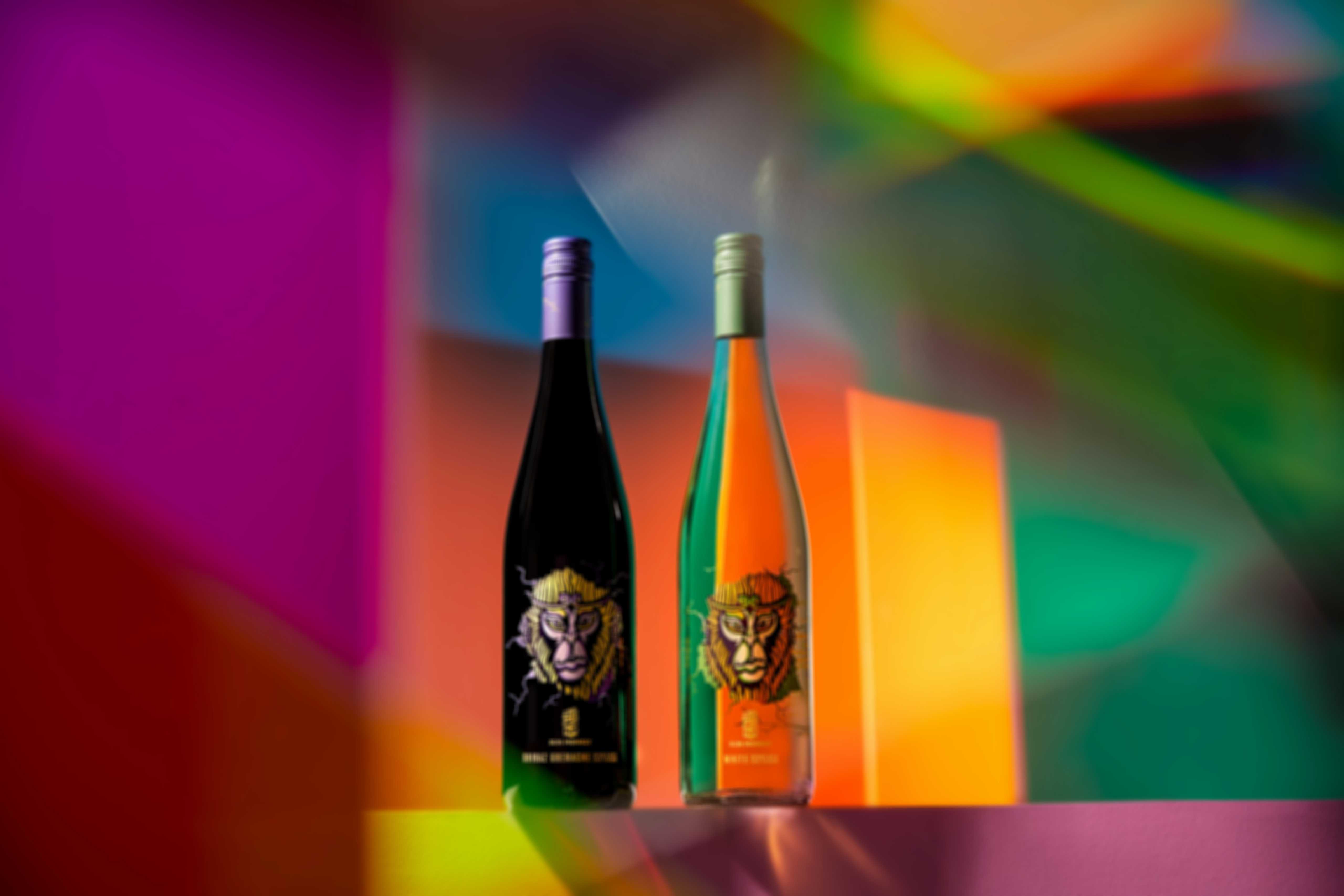 a-photo-of-two-bottles-of-sun-monkey-wine-sitting-among-a-rainbow