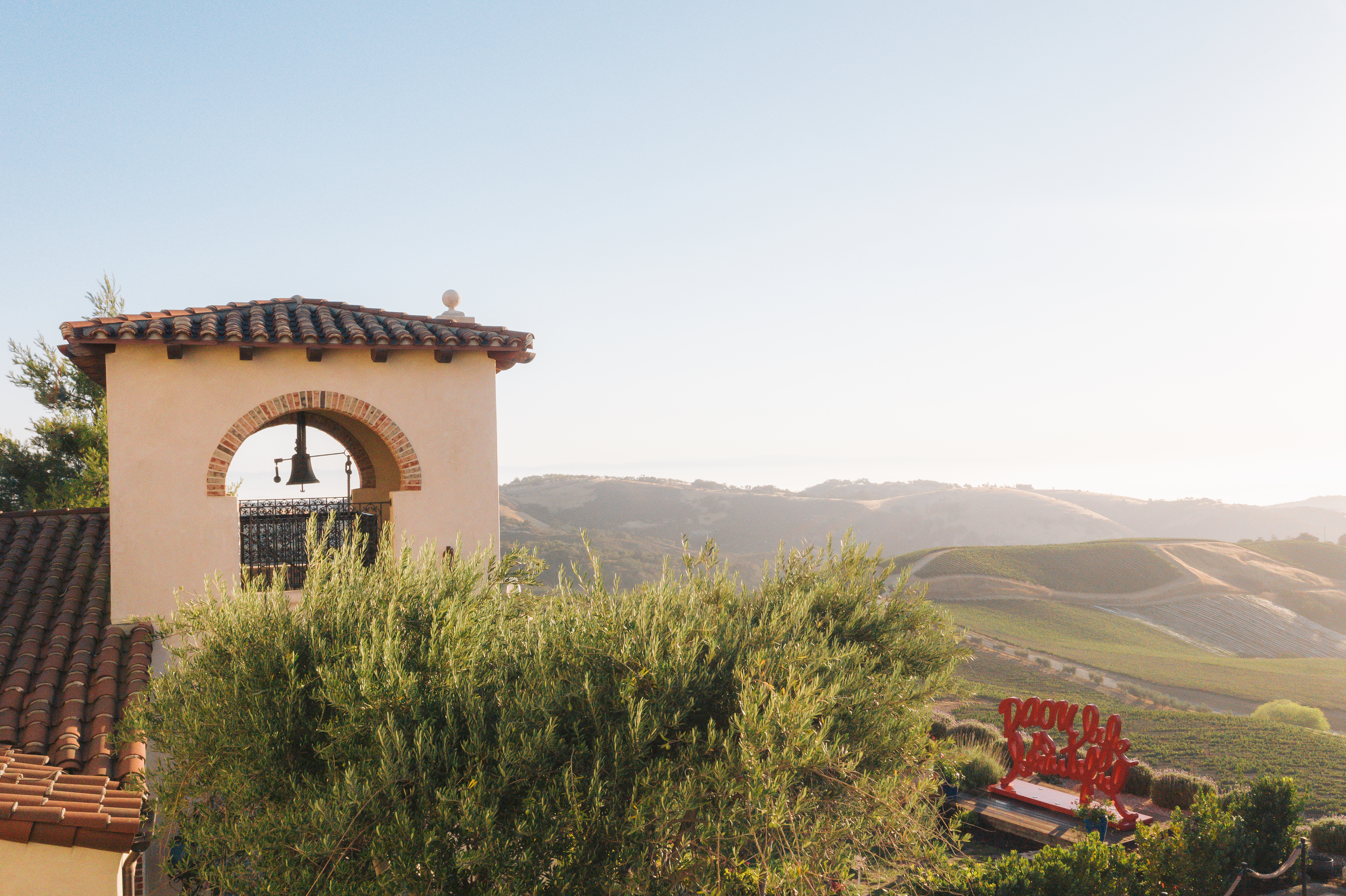 A small building in front of a mountain backdrop.