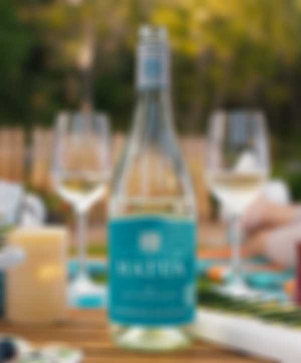 Bottle of Matua Sauvignon Blanc and two glasses on an outdoor table