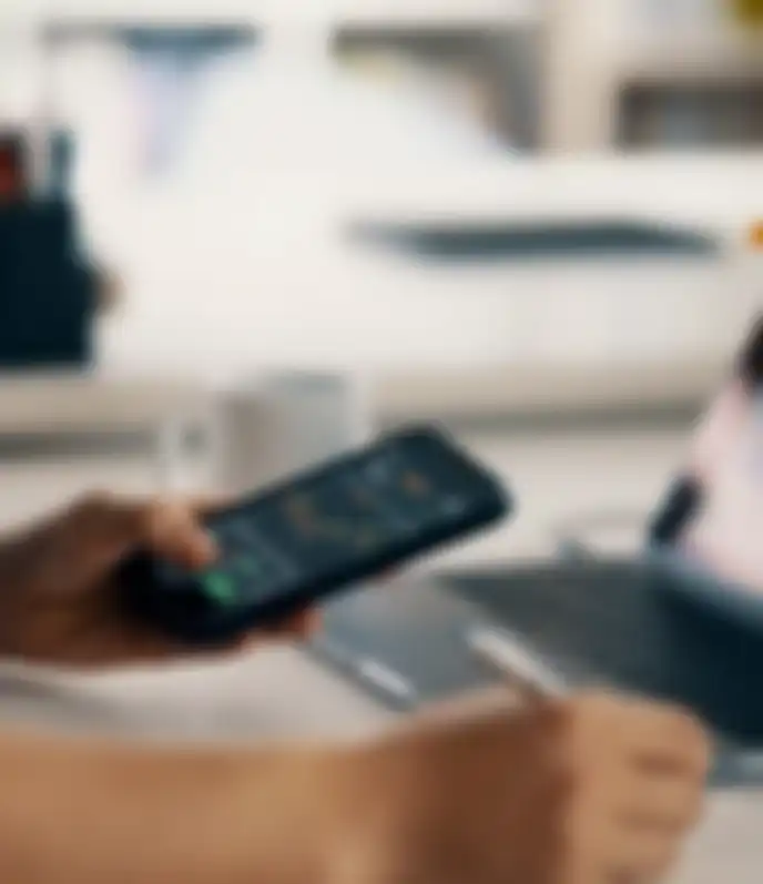 A person reviewing stocks on a phone