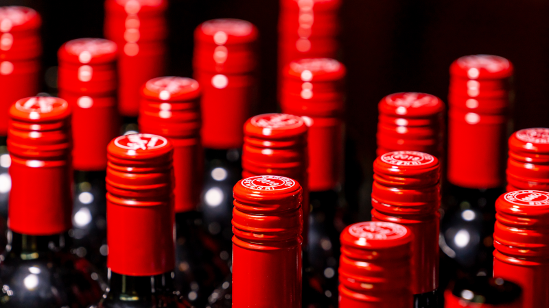 A row of red wine bottle caps