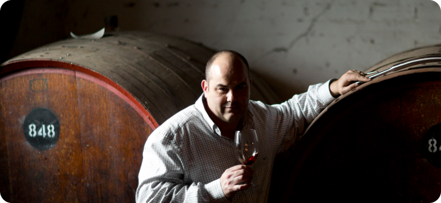 Richard posing with Wine barrels