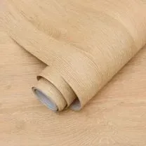 A roll of light wood-grain wallpaper partially unrolled on a matching wood-textured surface.