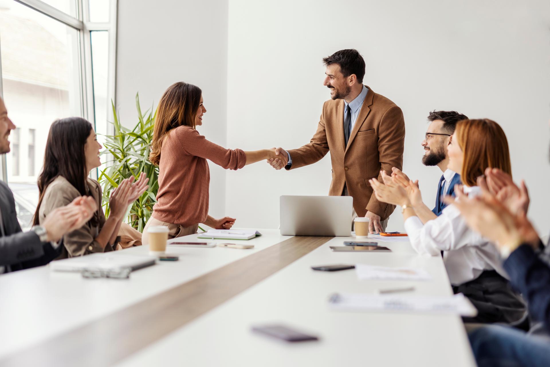 two_people_shaking_hands_in_office