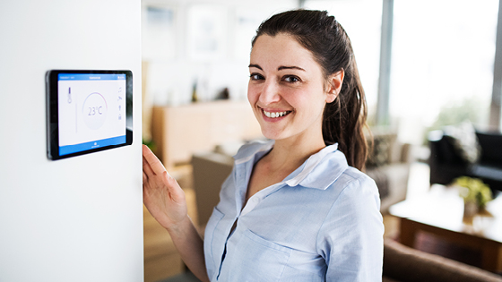 Frau vor Homescreen-Anzeige im Haus