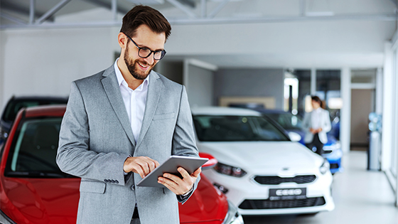 Mann mit Tablet in Autohaus