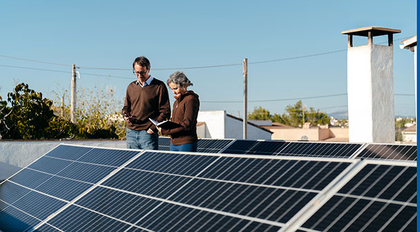 Zwei Personen begutachten die Photovoltaikanlage am Dach