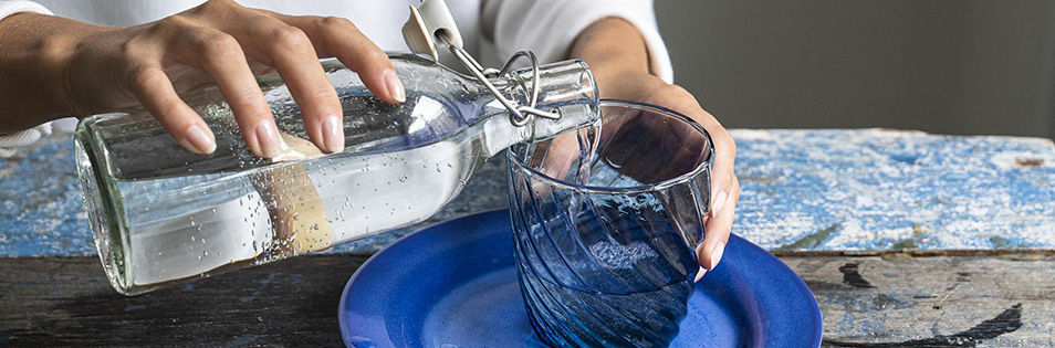 Wasser wird in ein Glas eingeschenkt