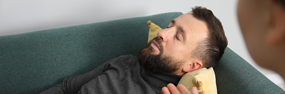 Mann mit geschlossenen Augen auf der Couch