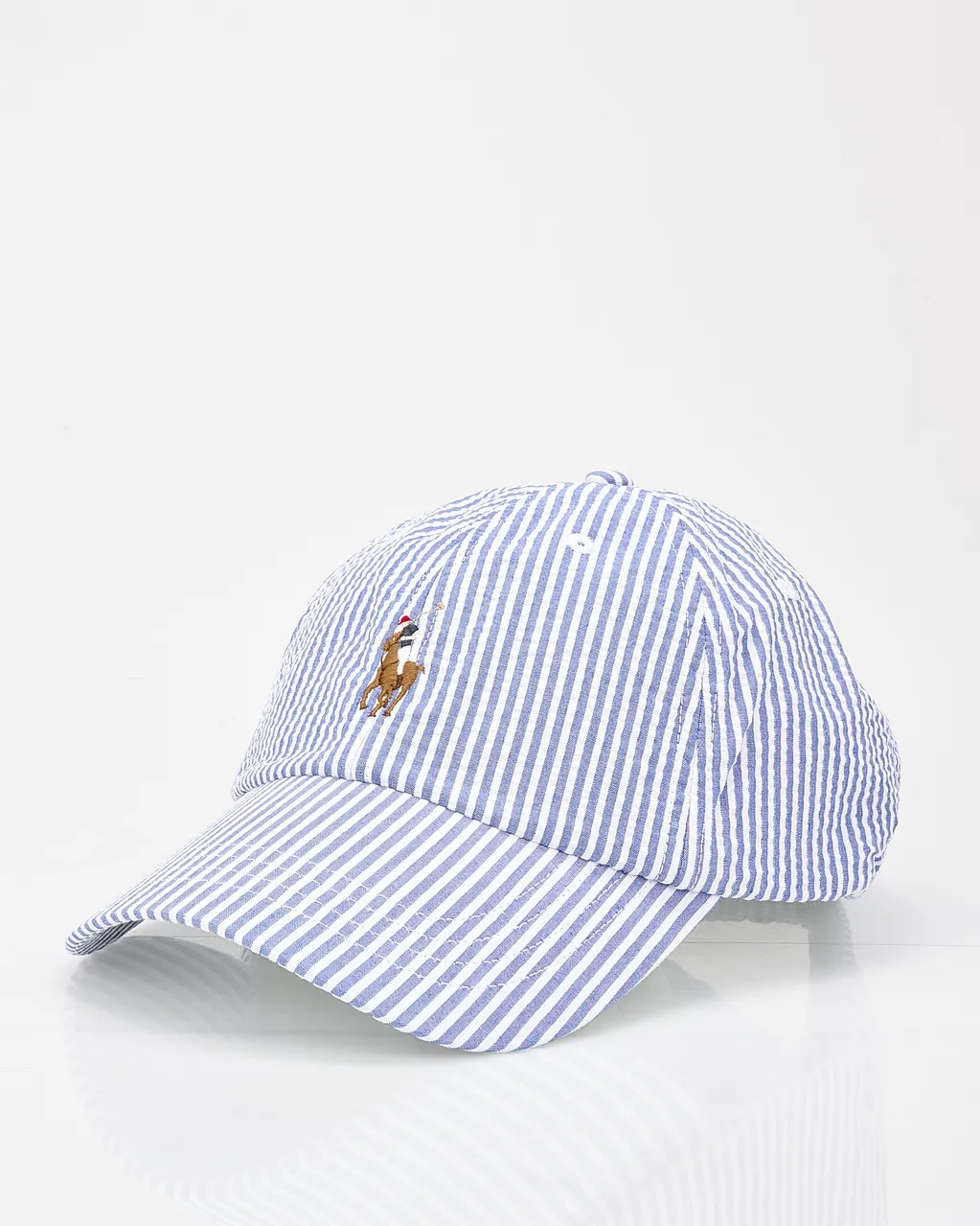 Blue and white striped baseball cap with an embroidered brown dog wearing a red cap on the front.