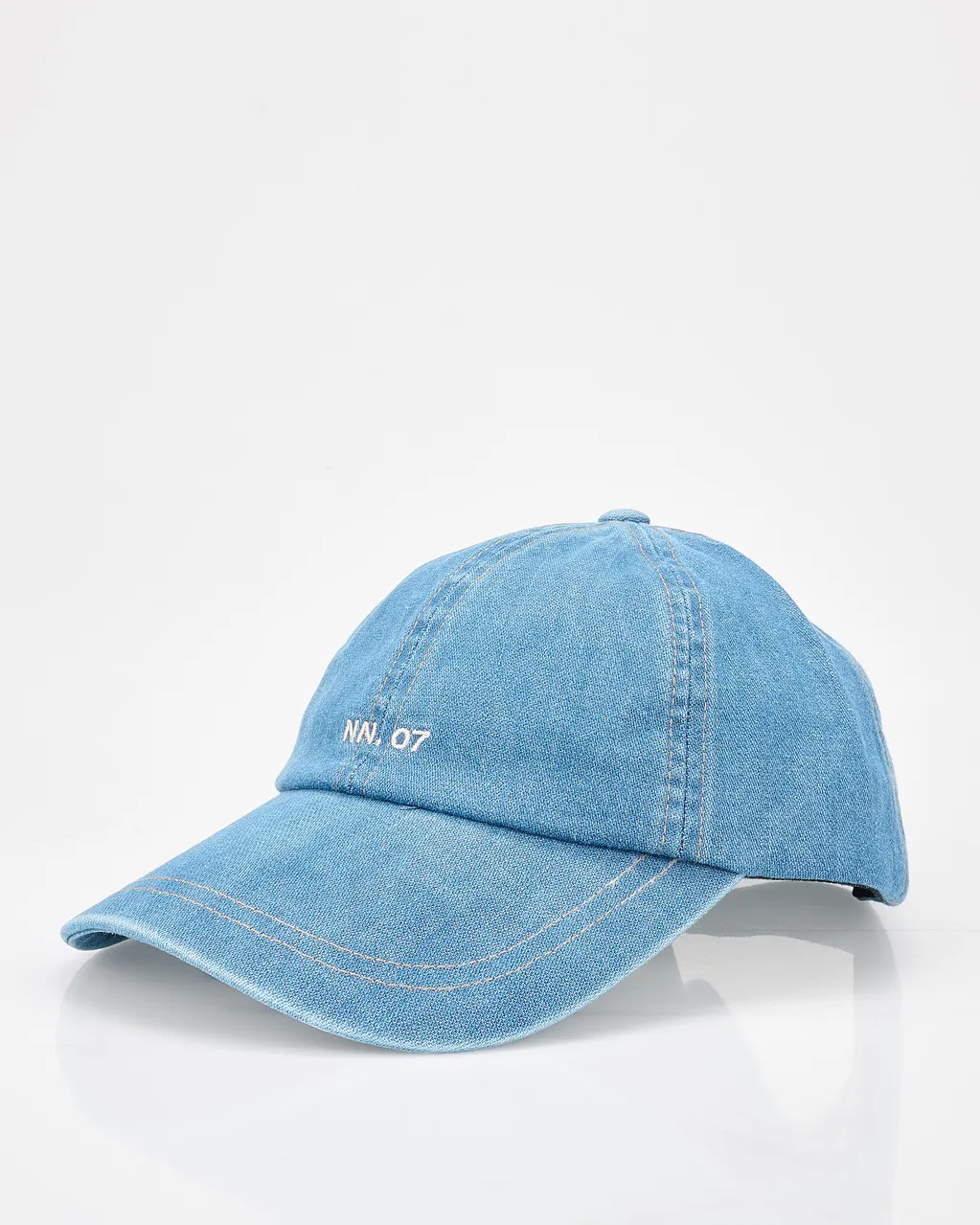 A light blue denim baseball cap with white embroidered text "NN. 07" on the front, set against a plain white background.