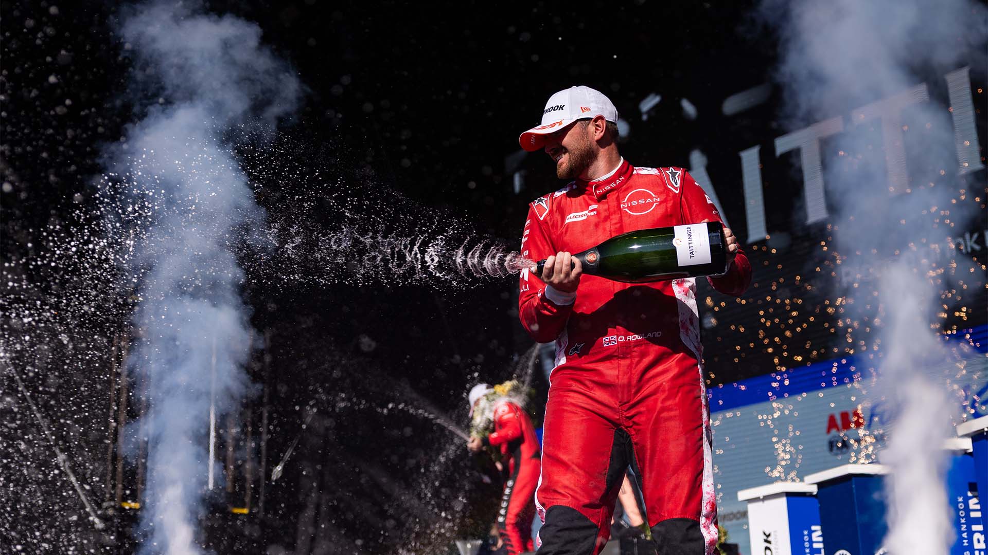 Oliver Rowland sprays champagne on the Berlin podium