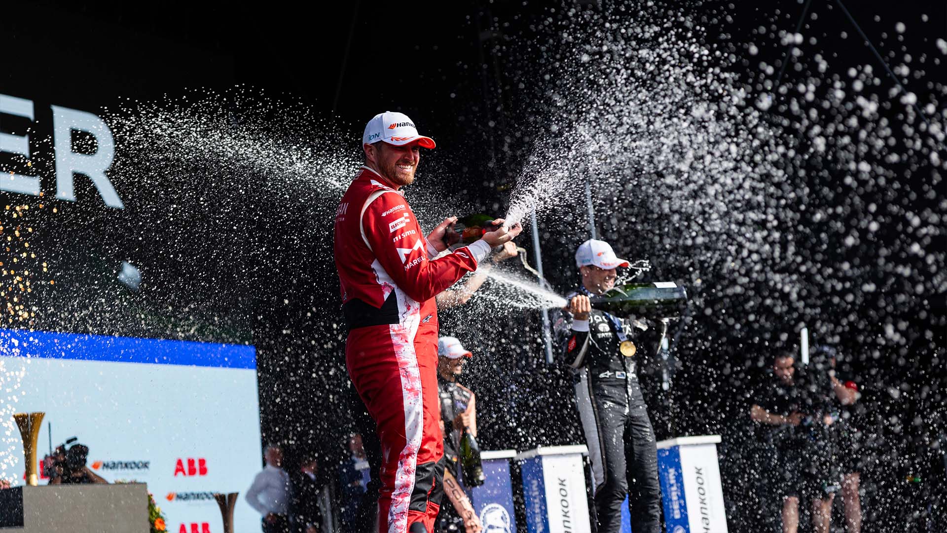 Oliver Rowland sprays champagne on the Berlin podium