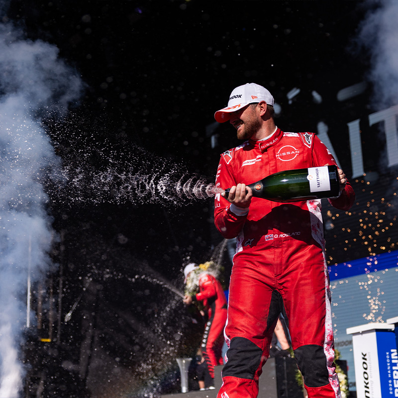 Oliver Rowland sprays champagne on the Berlin podium