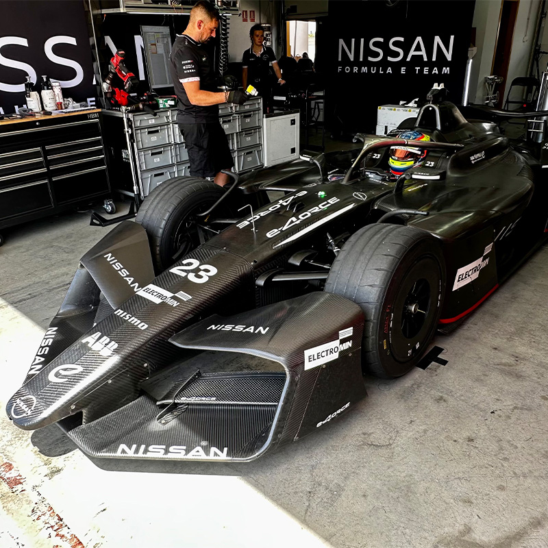 Oliver Rowland sits in the Nissan Formula E Team GEN4 car in the garage