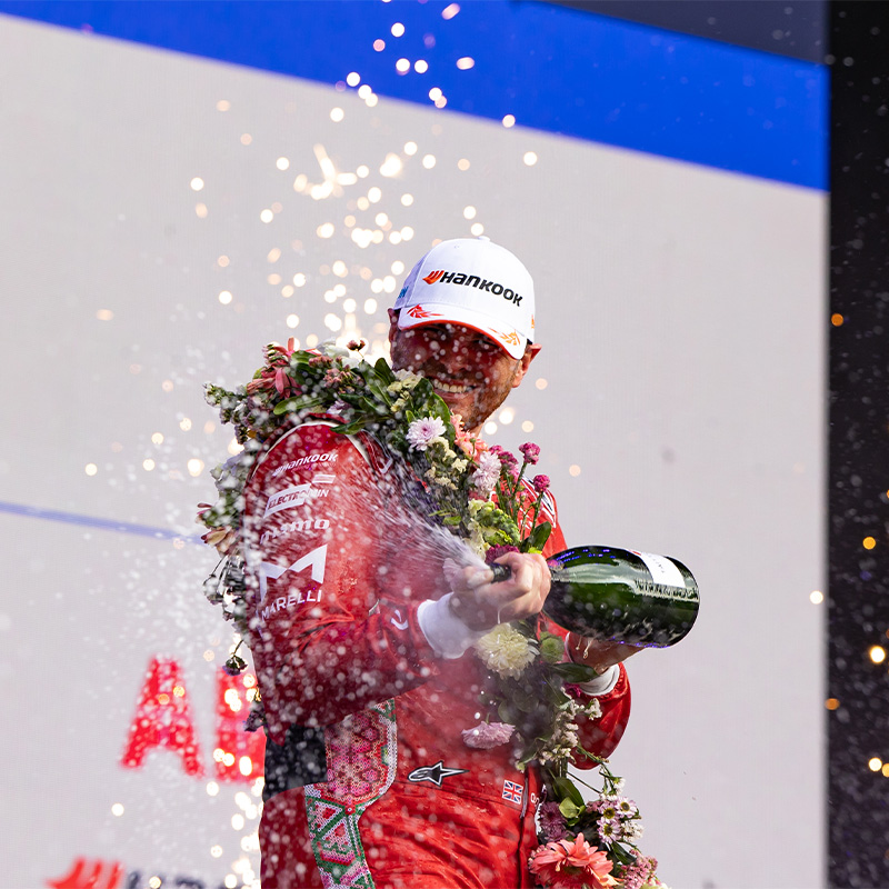 Oliver Rowland sprays champagne on the Mexico City podium