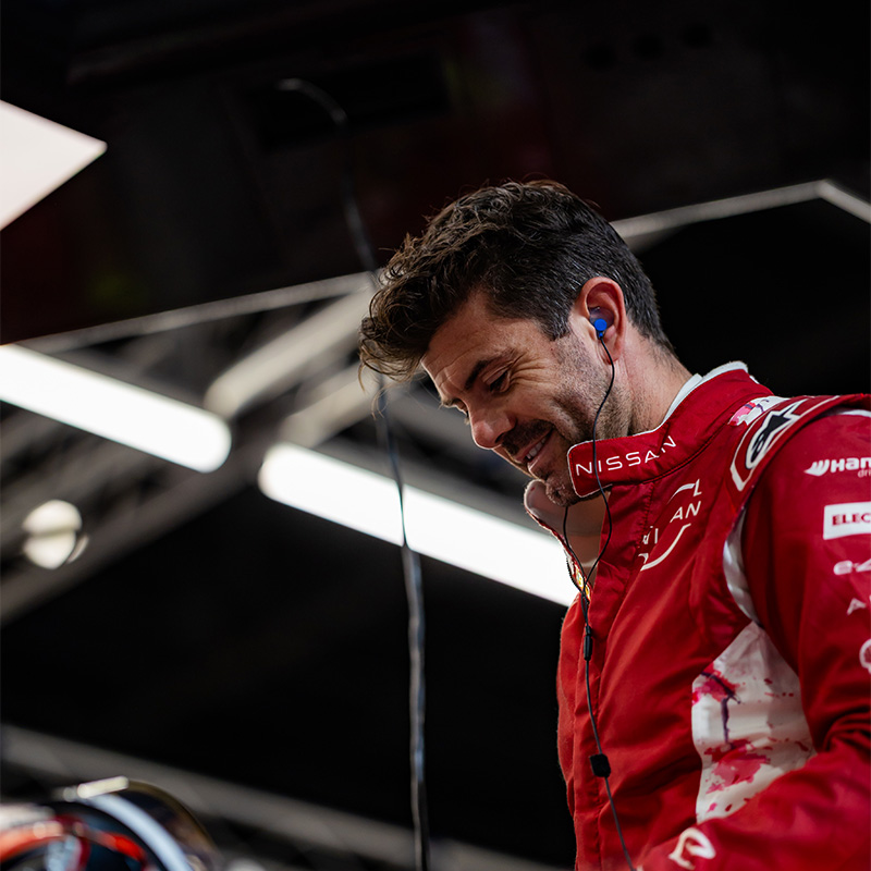 Norman Nato smiling in his race suit