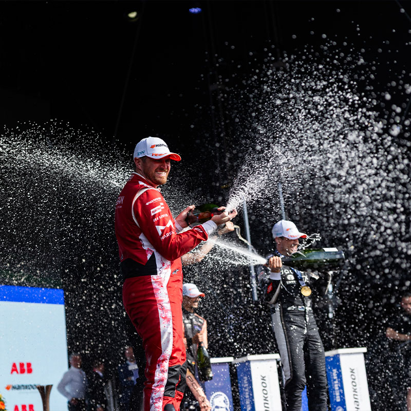 Oliver Rowland sprays champagne on the Berlin podium