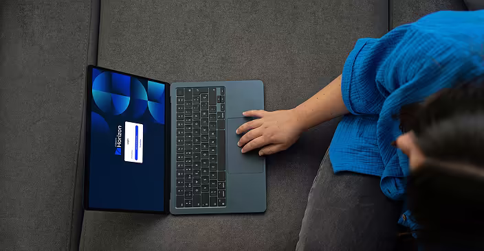 Woman using a laptop on a sofa