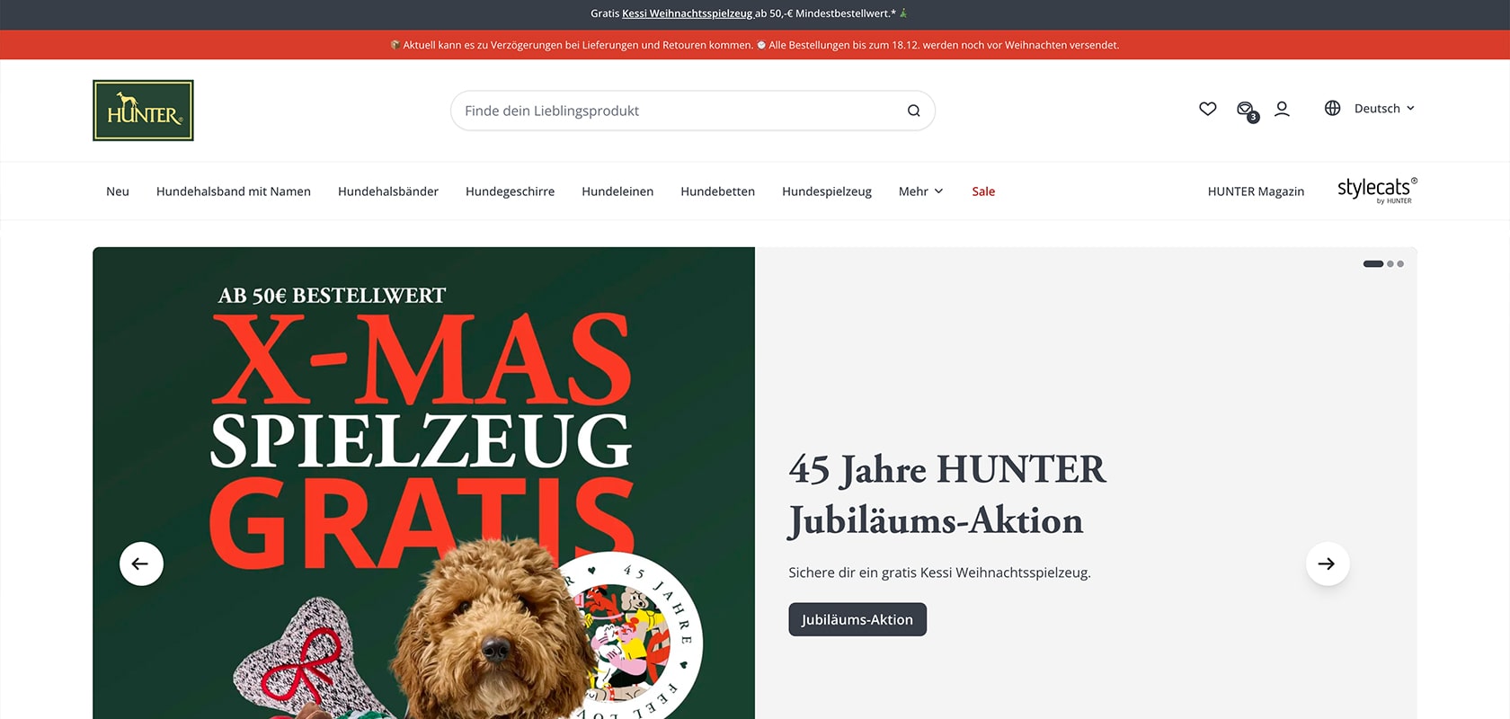HUNTER-Website-Startseite mit einer grünen Weihnachtsaktion mit einem lockigen braunen Hund, dem Banner „X-MAS SPIELZEUG GRATIS” und dem Jubiläumstext „45 Jahre HUNTER”.