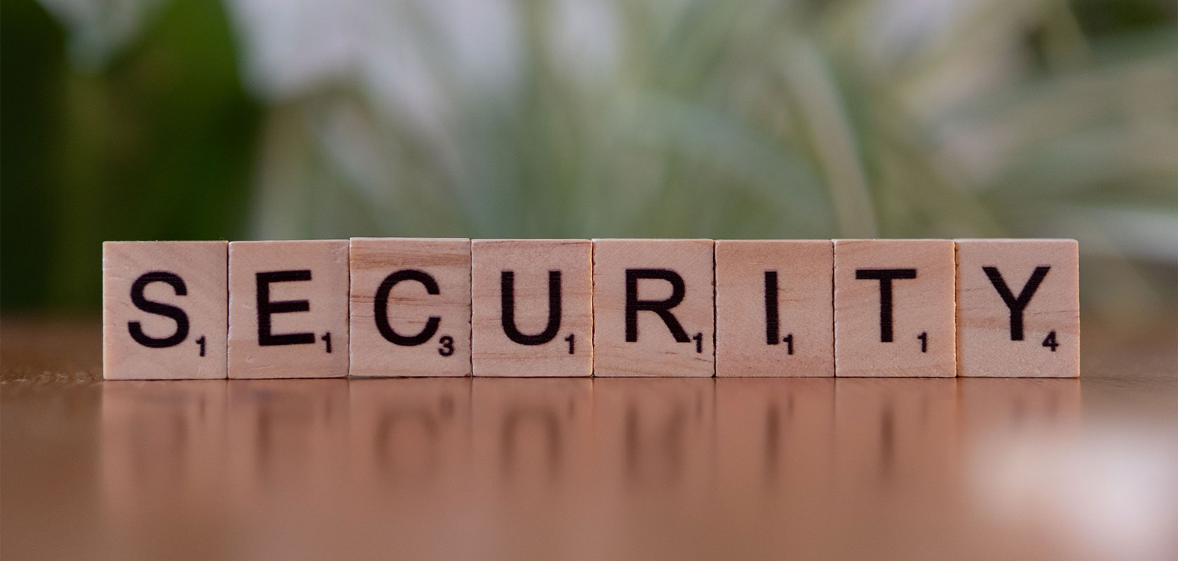 Das Wort „SECURITY“ gelegt aus Holz-Buchstabensteinen.