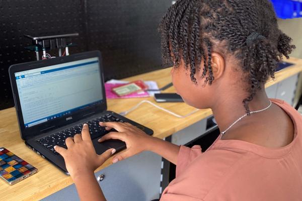 Young people working on robotics kits at the Hector Foundation's maker labs in Haiti.
