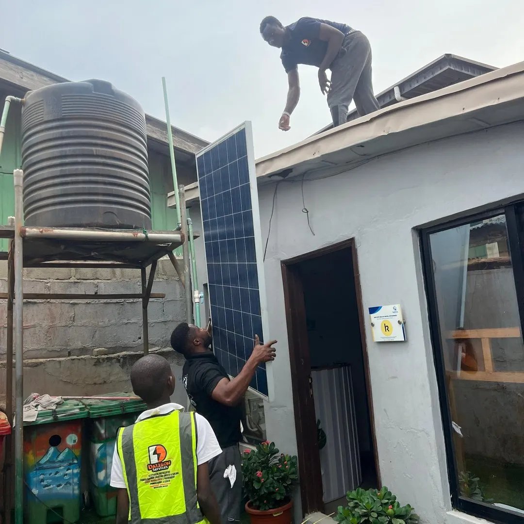 Three solar panels mounted on the corrugated metal roof of Safe City clinic in Oworoshoki.