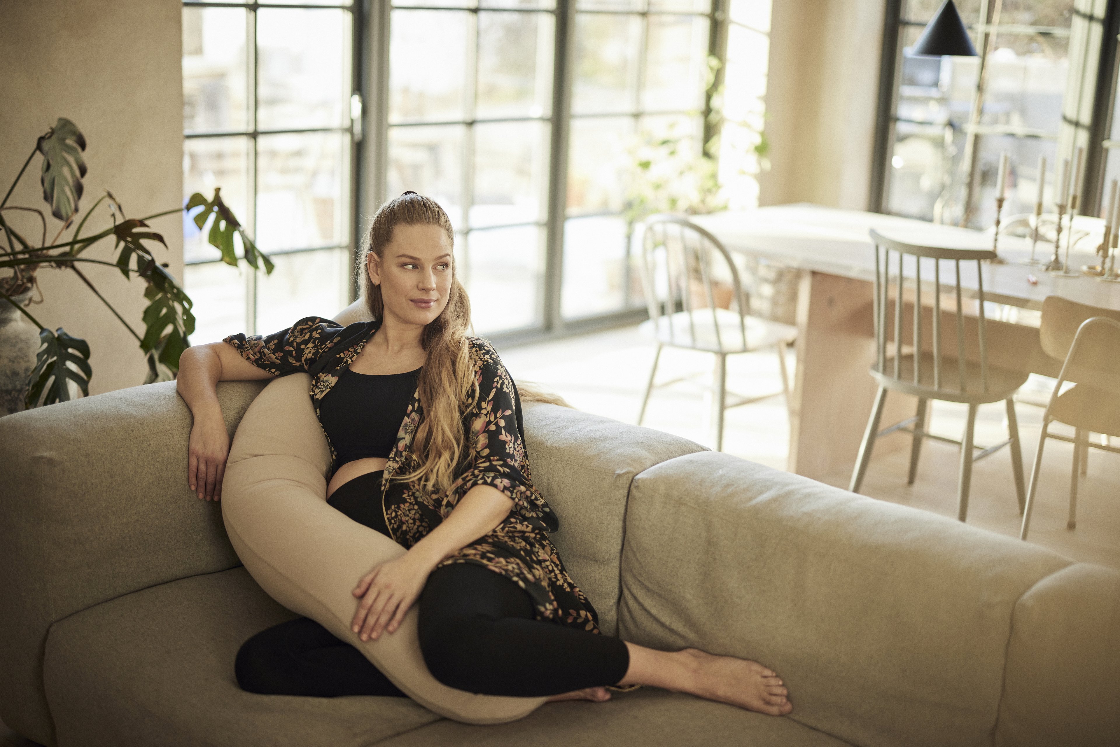 nursing woman using najell pregnancy pillow as a nursing pillow