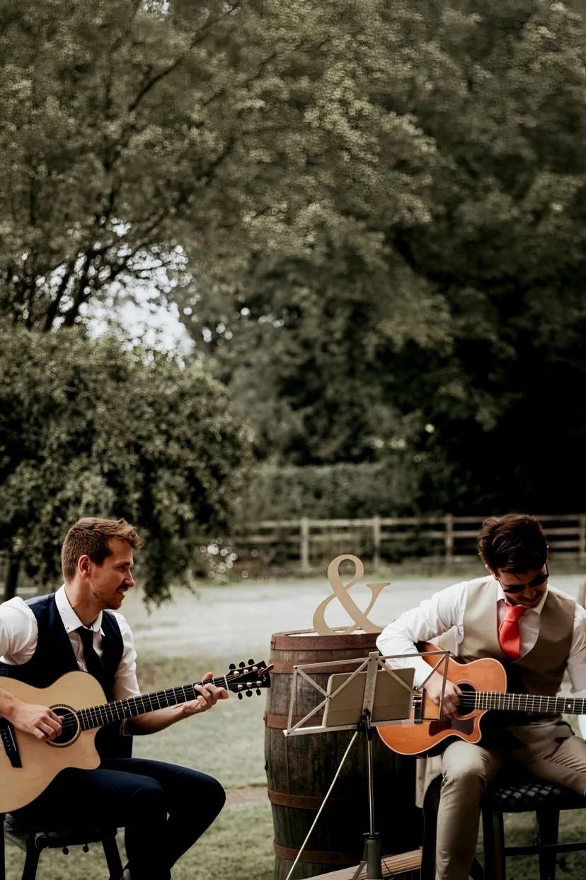 Tangerine Republic acoustic guitar duo performing at an outdoor wedding ceremony