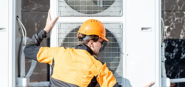 Ein Arbeiter installiert eine Wärmepumpe.