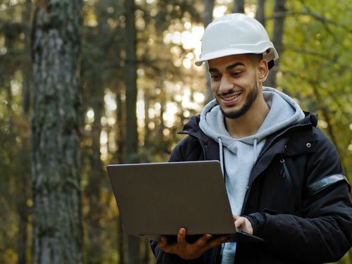 Bright IT - Man with construction helmet and laptop