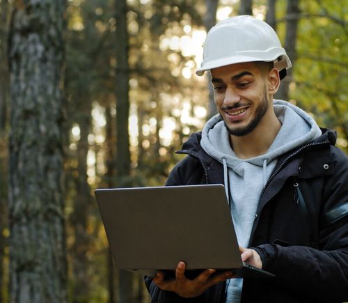 Bright IT - Man with construction helmet and laptop