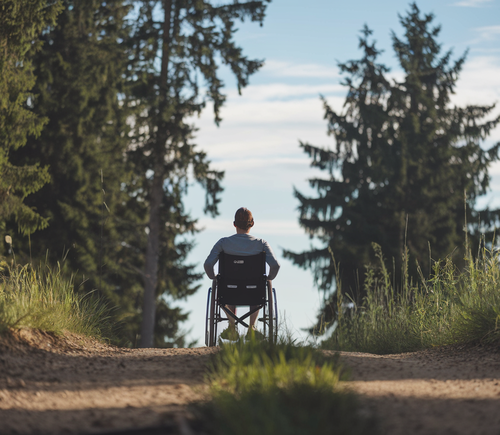 Silhouette of a person in wheel chair