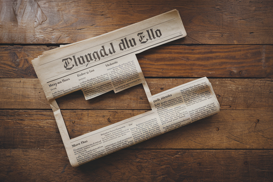 Photography of a newspaper with cut out images making it impossible to grasp the whole picture of an article