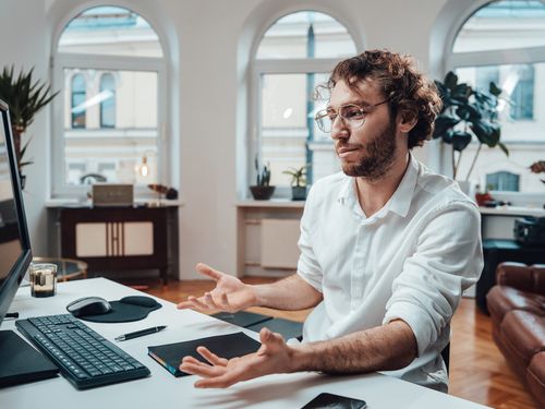 confused man at computer desk