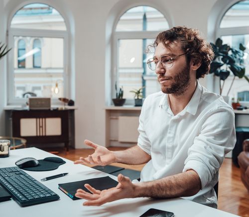 confused man at computer desk