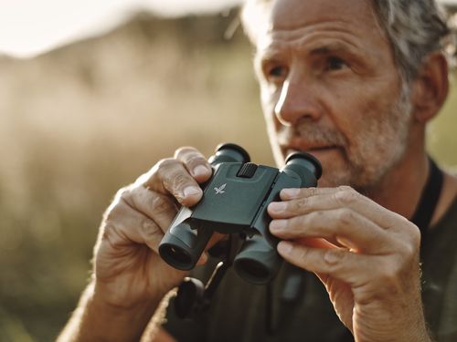 Man with binoculars from SWAROVSKI OPTIK