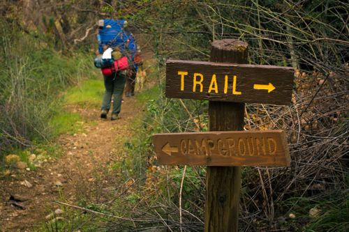Sign in front of hiking trail in forest