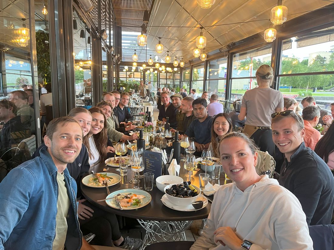 The team at a long dinner table in a restaurant
