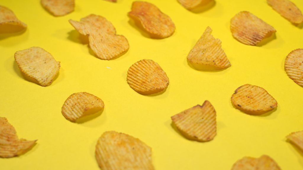 Potato chips on a yellow table