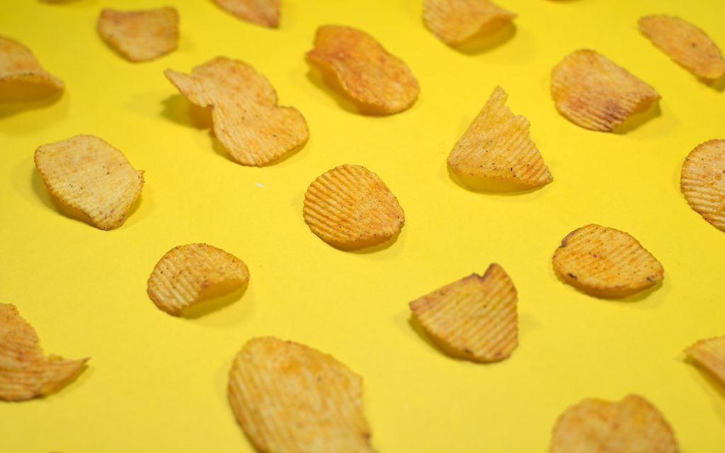 Potato chips on a yellow table