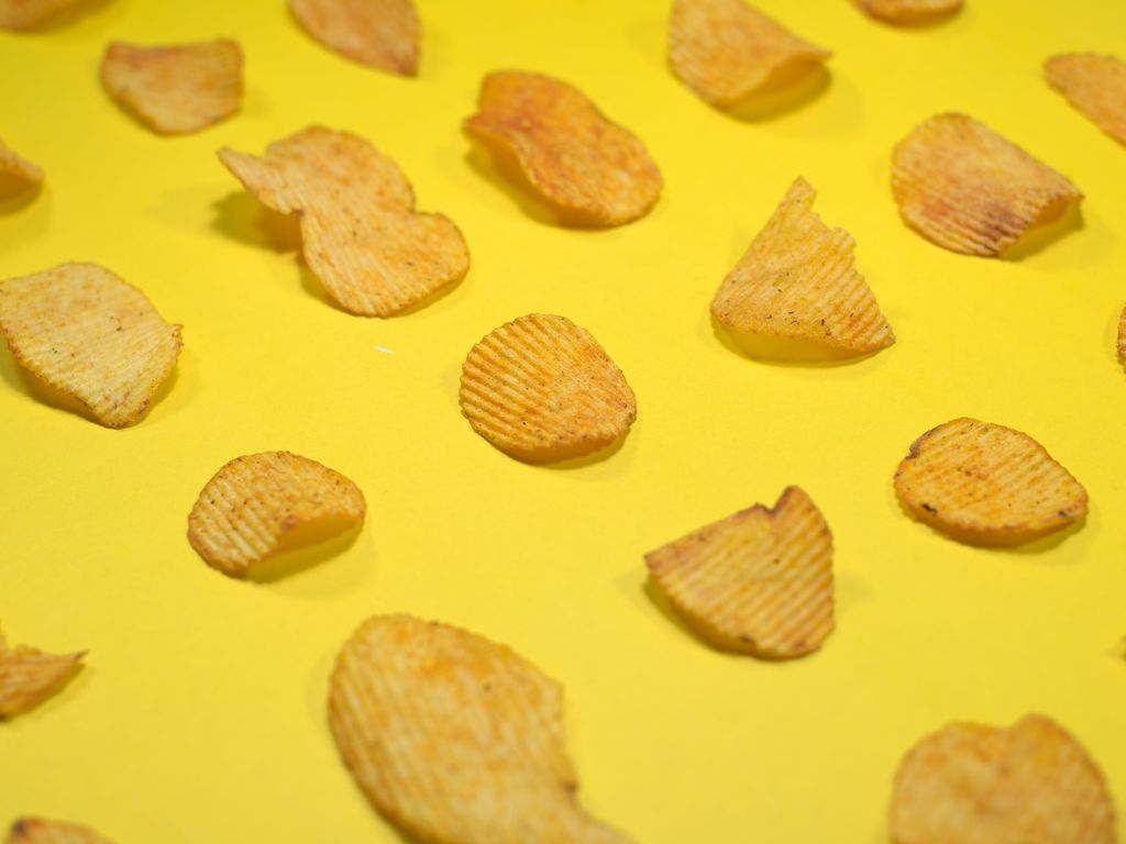 Potato chips on a yellow table