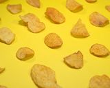Potato chips on a yellow table