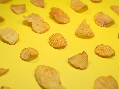 Potato chips on a yellow table