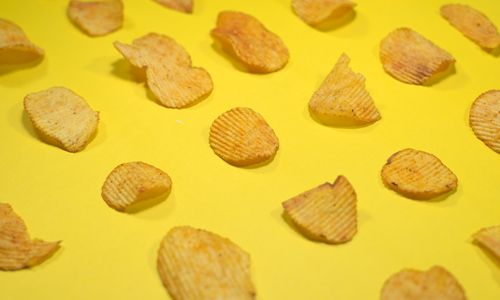 Potato chips on a yellow table